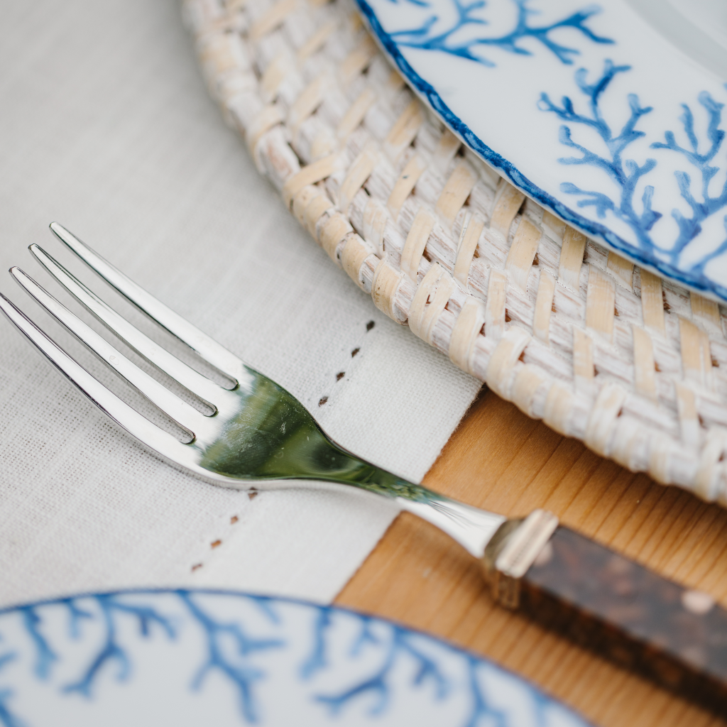 Tortoiseshell fork on top of pintuck edge of white cotton table runner