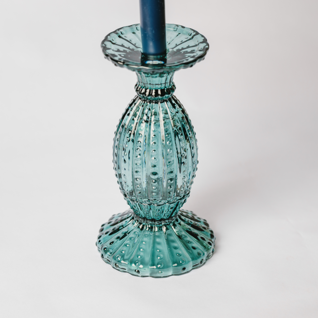 Scalloped aquamarine glass candle holder with navy tapered candle