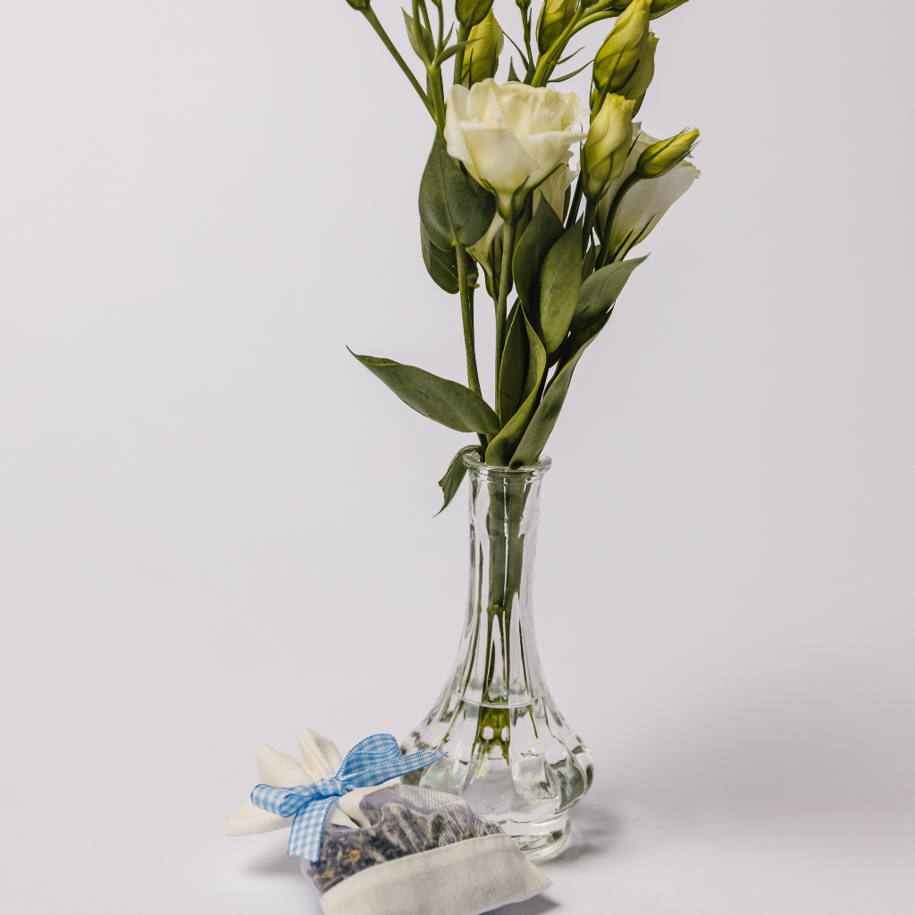 A mini onion-style bud vase and pouch of dried lavender with blue gingham bow tie
