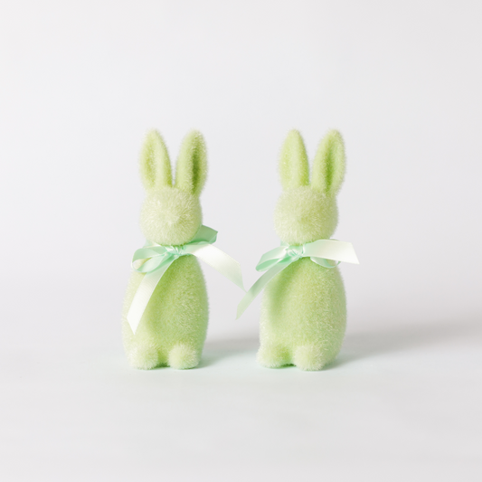 A pair of mint green flocked bunny decorations with matching ribbon ties round the neck.