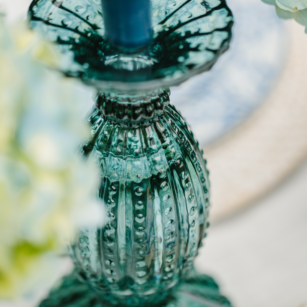 Close up view of fluted edging on aquamarine glass candle holder