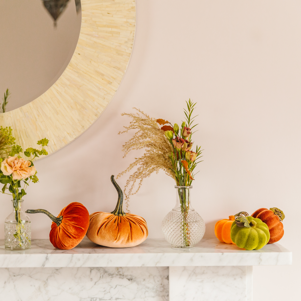 Halloween mantlepiece display with flocked pumpkins, velvet pumpkins and bud vase home decorations