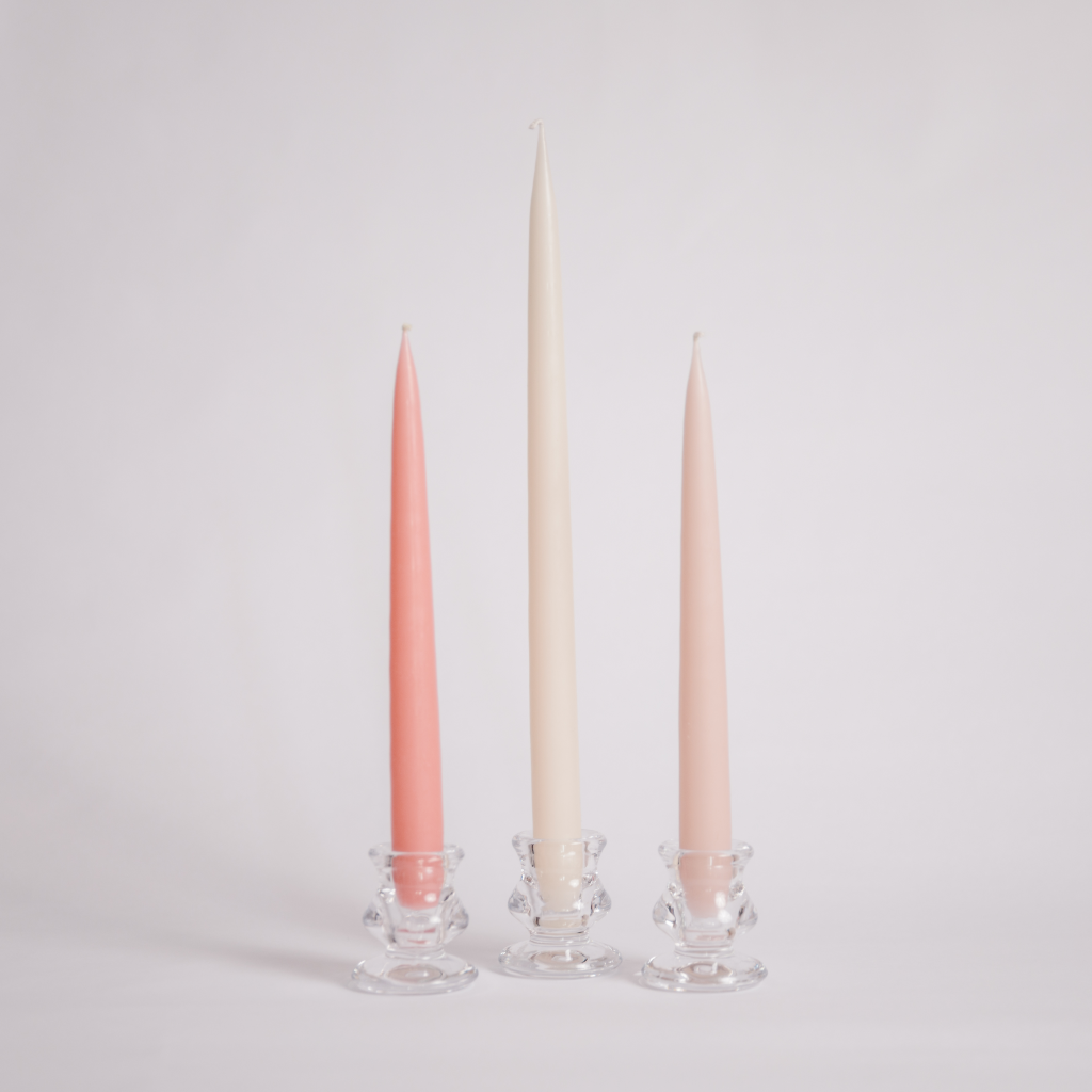 The Peaches and Cream tapered dinner candle set displayed as a trio with a powder pink, vintage rose pink and tall off white tapered candle