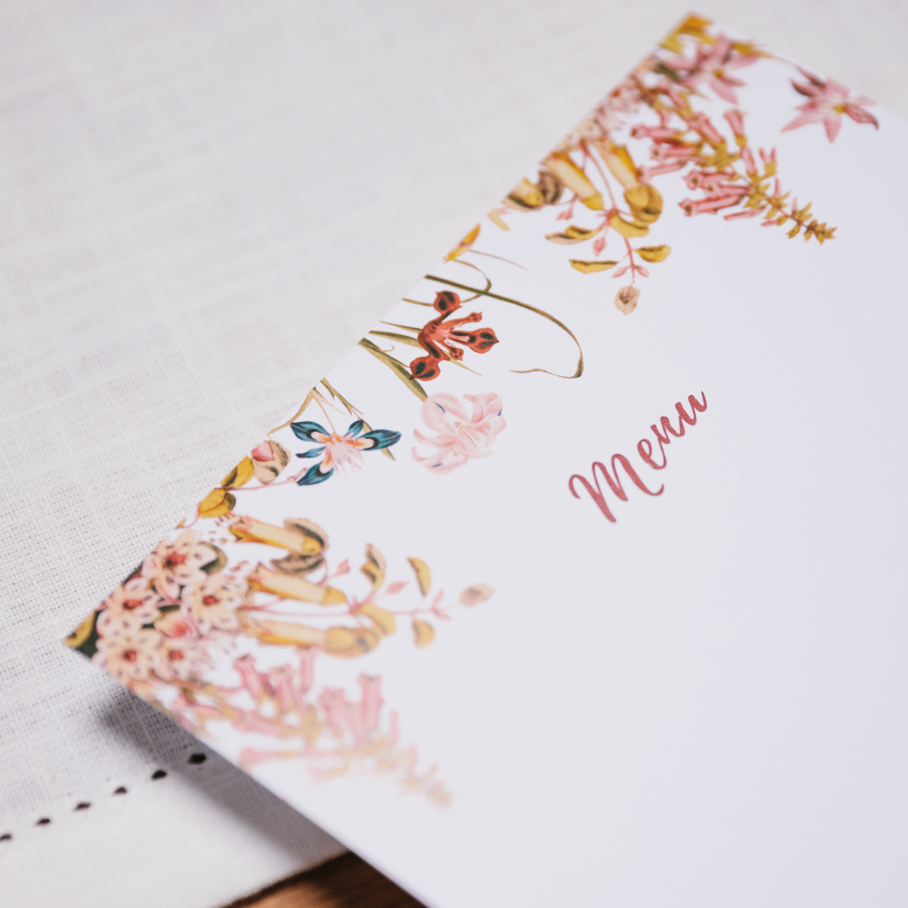 Close up of pink and red floral design on bespoke Truffle menu card for tablescape