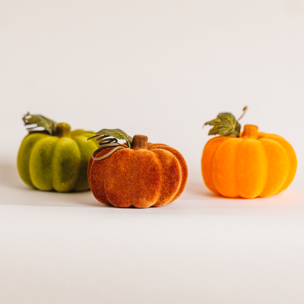 Trio of flocked pumpkin Halloween decorations in rust, pumpkin and moss colours