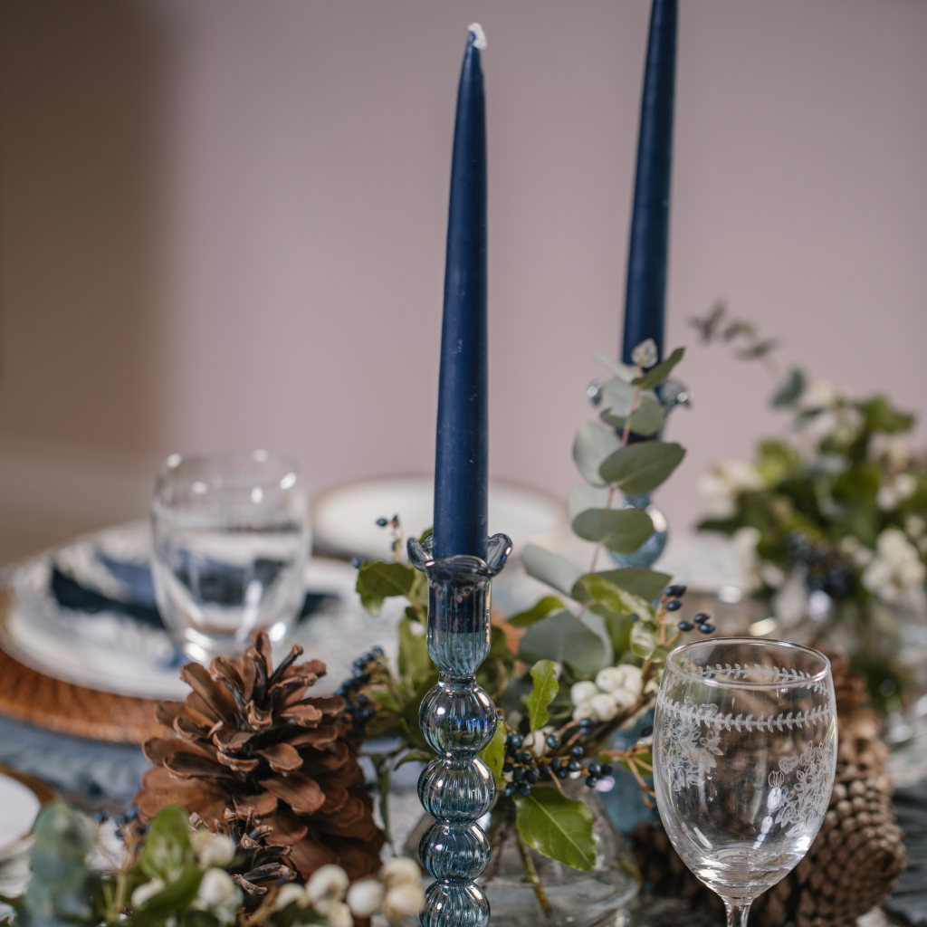 Navy tapered dinner candles displayed in powder blue hand blown candle holders set on the Twilight tablescape central display.