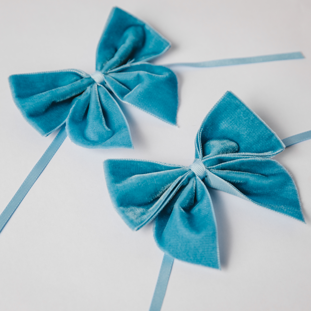 Duo of kingfisher blue velvet napkin bows with ribbon tie