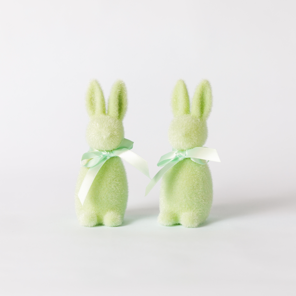 A pair of mint green flocked bunny decorations with matching ribbon ties round the neck.