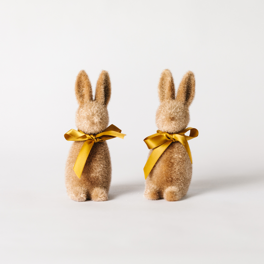 A pair of soft brown flocked bunny decorations with matching ribbon ties round the neck.