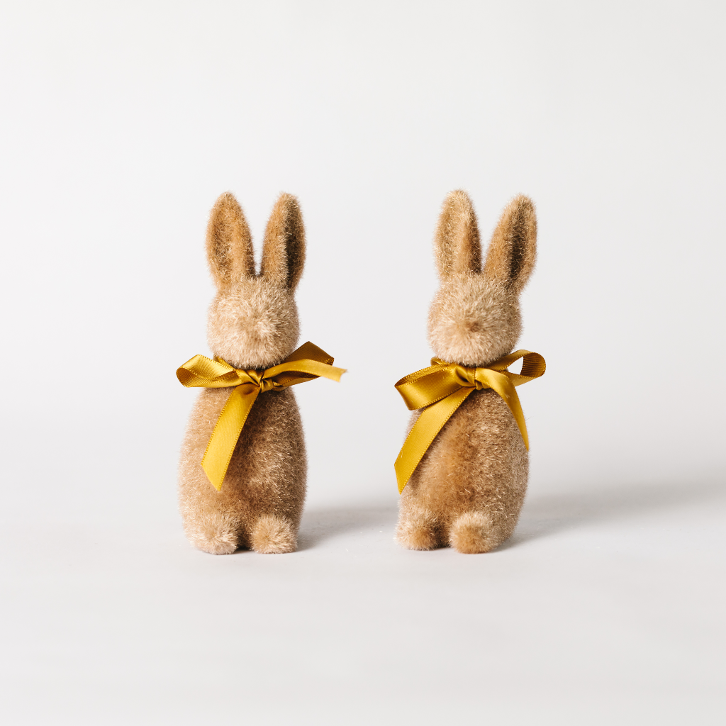 A pair of soft brown flocked bunny decorations with matching ribbon ties round the neck.