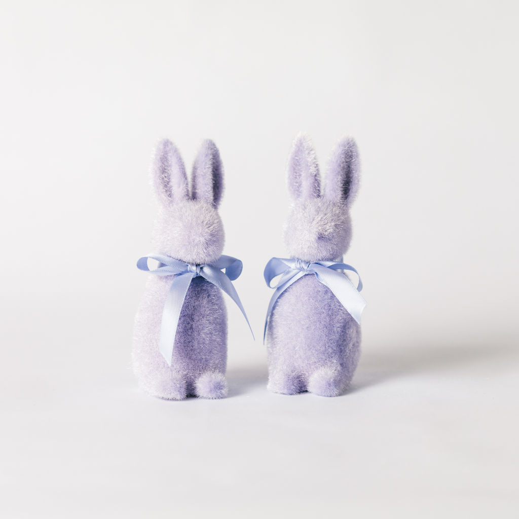 A pair of lilac flocked bunny decorations with matching ribbon ties round the neck.