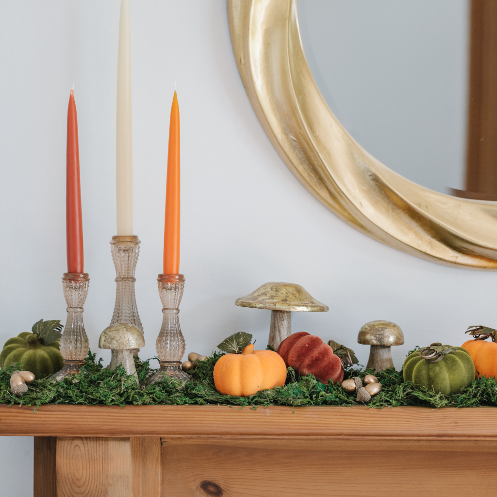 Harvest Hallowe'en mantle decorations including golden toadstools, flocked pumpkins and Pumpkin Patch tapered dinner candles in light gold glass candle holders