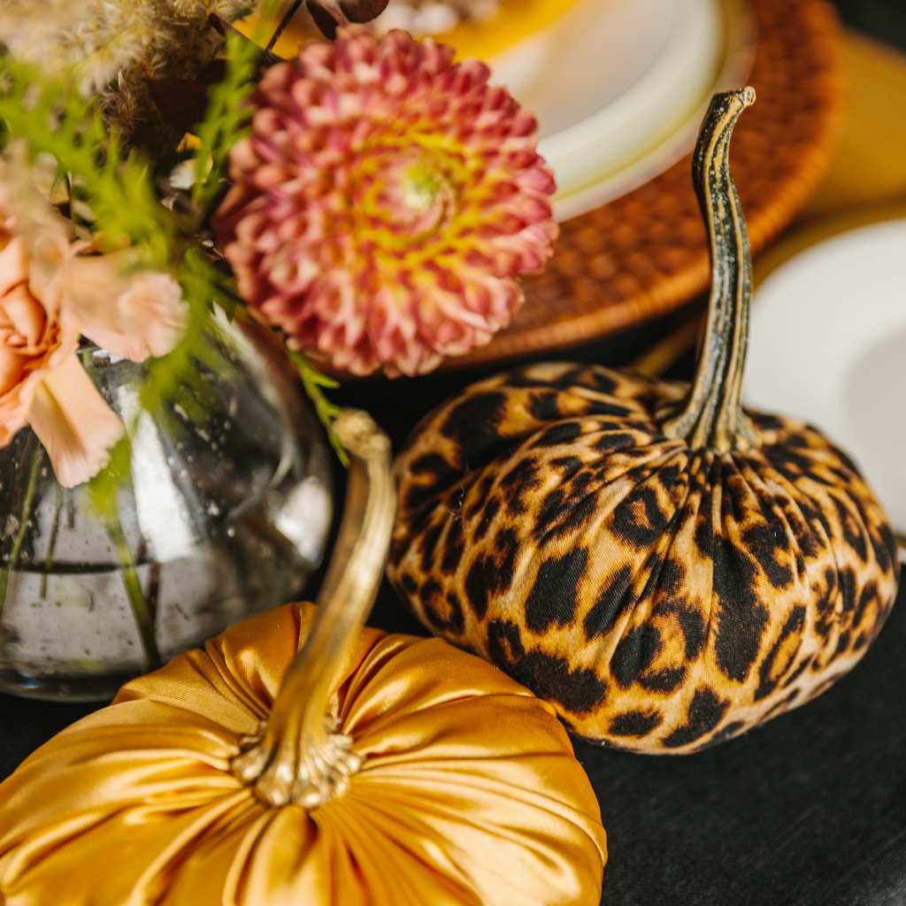 Luxe leopard print pumpkin with resin stem next to a gold satin handmade Hallowe'en pumpkin decoration