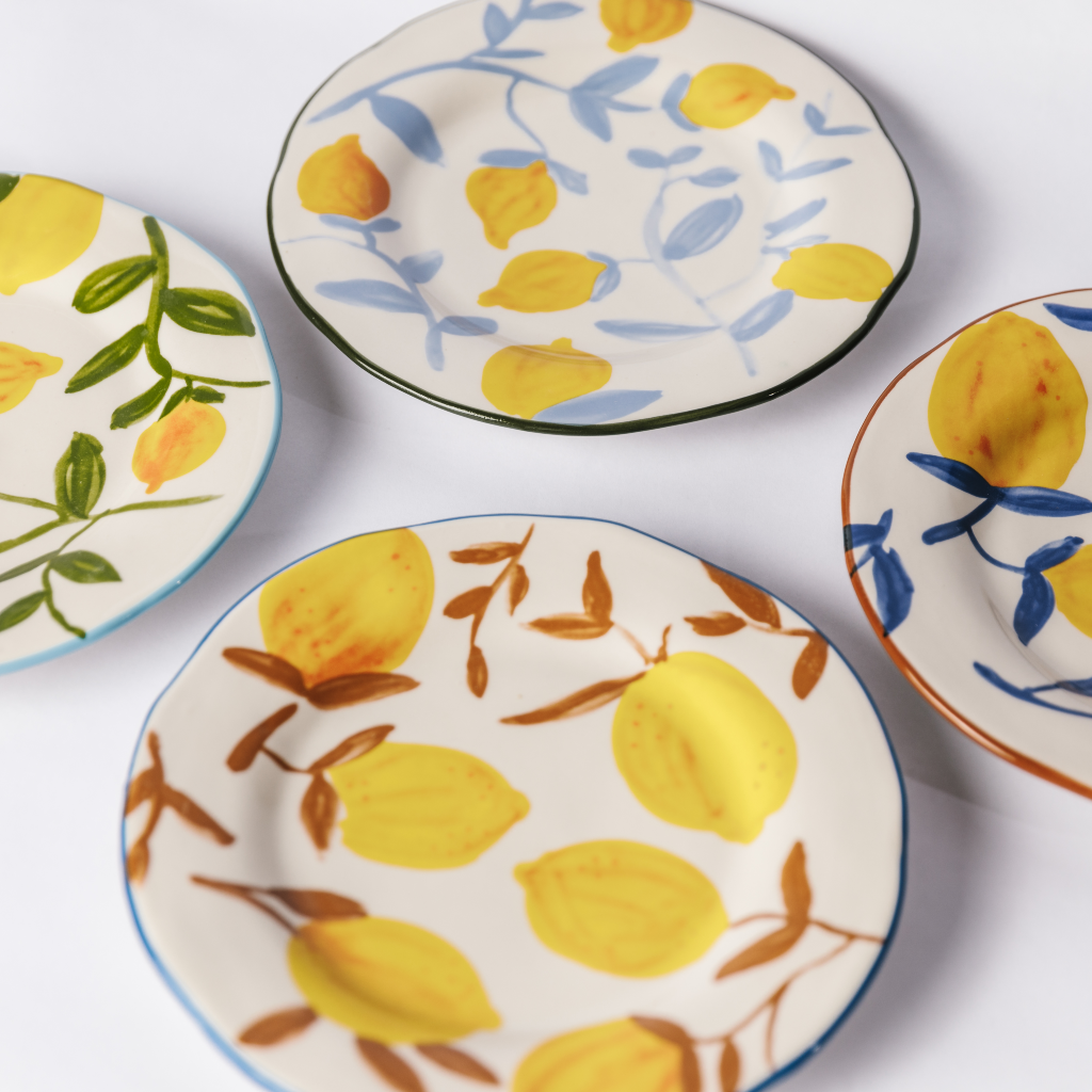Set of four stoneware yellow lemon and twig design plates