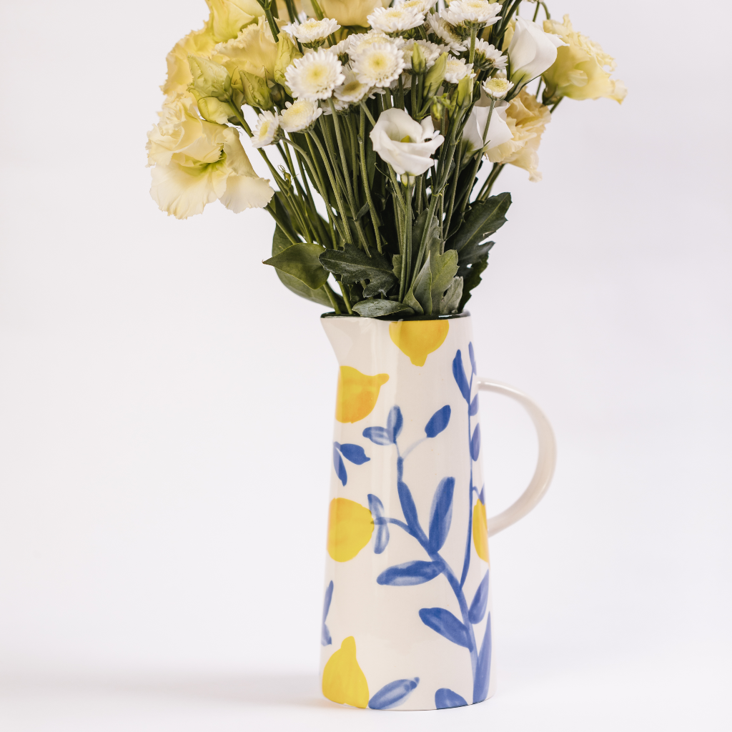 Lemon Grove Carafe displaying white and yellow posy of flowers
