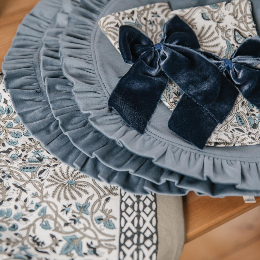 Bourbon blue velvet ruffled placemats with navy blue velvet napkin bows and Indian block printed table linens.