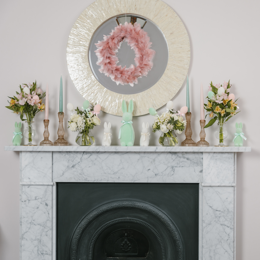 White marble mantlepiece decorated with champagne gold, mint green, cream and pink Easter decorations