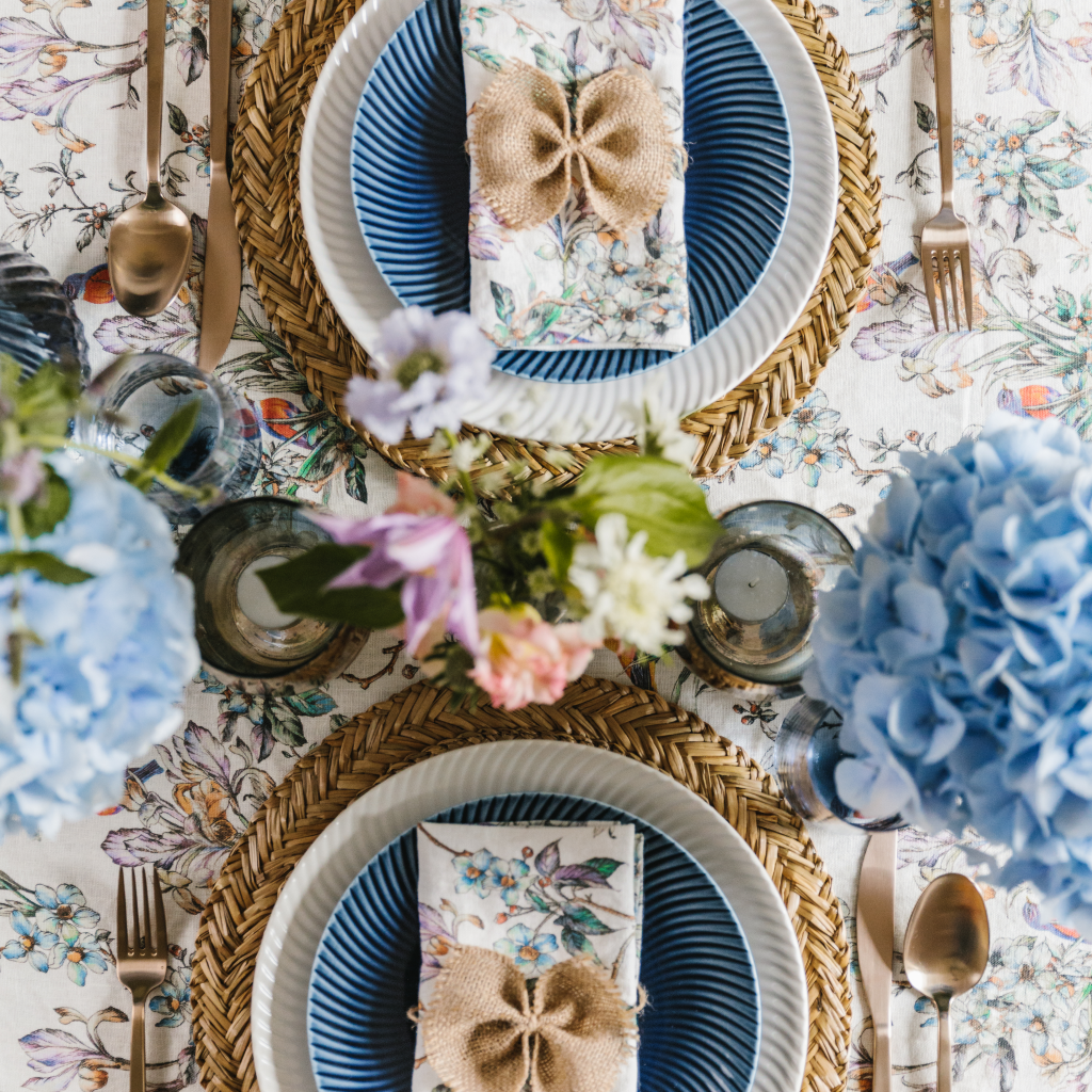 Seagrass placemats forming part of a two-person tablescape setting from the Wildflower Garden Collection.