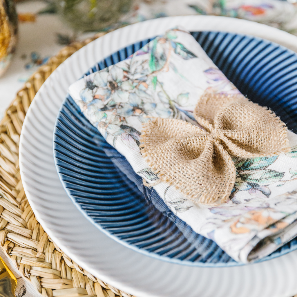 Denby Porcelain Collection navy arc pattern starter plate and white arc pattern main plate set with linen napkin and hessian napkin bow.